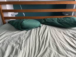 How to keep pillows from falling behind bed