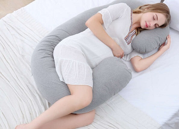 woman sleeping with grey full body pillow