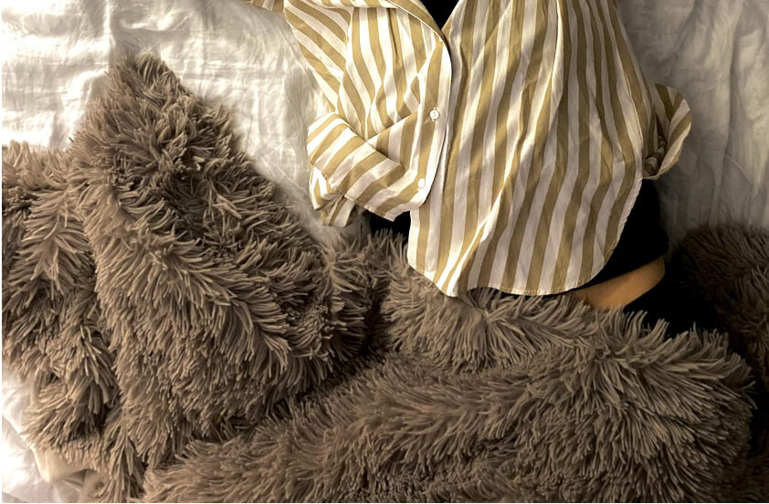women sleeping with snug brown blanket
