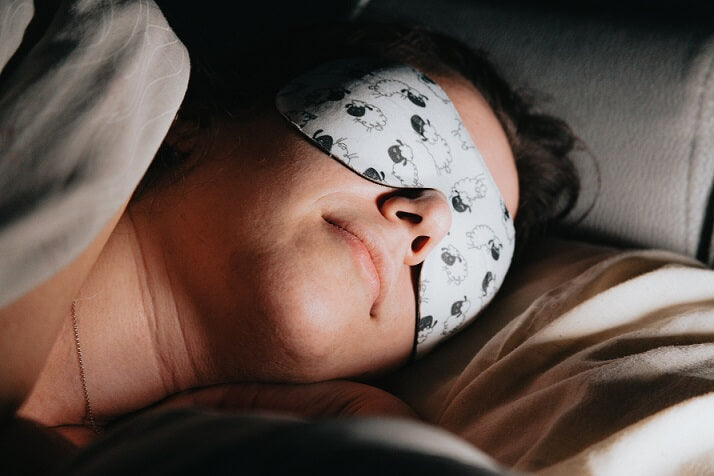 woman sleeps while wearing a mask