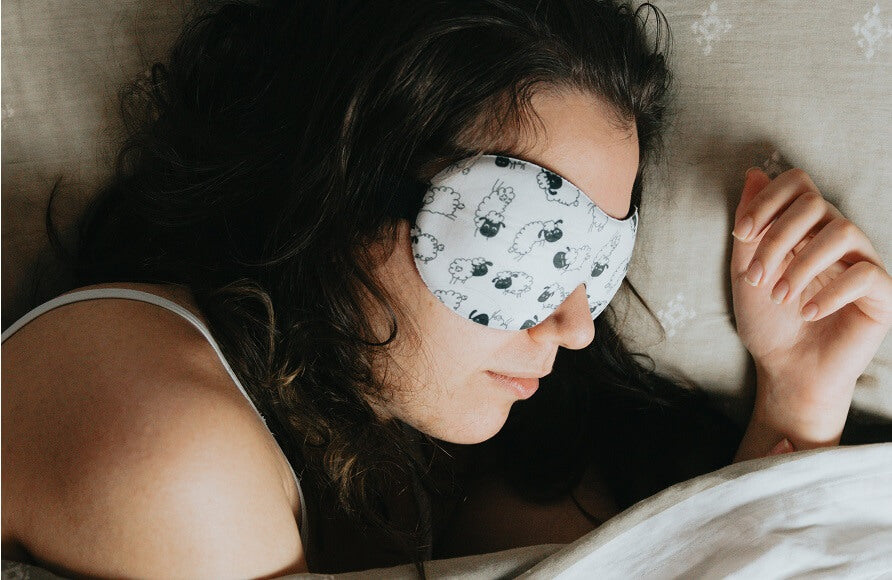woman sleeping with an eye mask